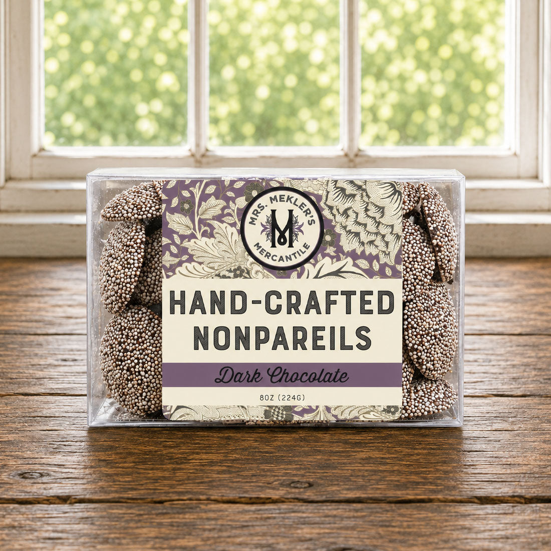 A clear plastic box of Dark Chocolate Nonpareils