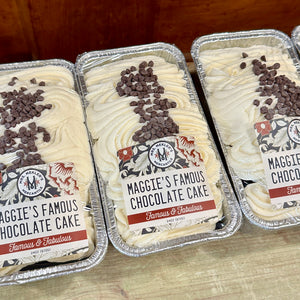 Promotional image for Mrs. Mekler's Mercantile featuring Easter pre-orders for baked goods such as cakes, pies, and breads with decorative elements like a rabbit, flowers, and leaves on a green background.