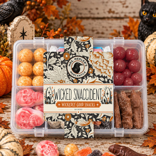 Wicked Snaccident Halloween snack box with assorted sweet treats in a divided container with a decorative Halloween sleeve.